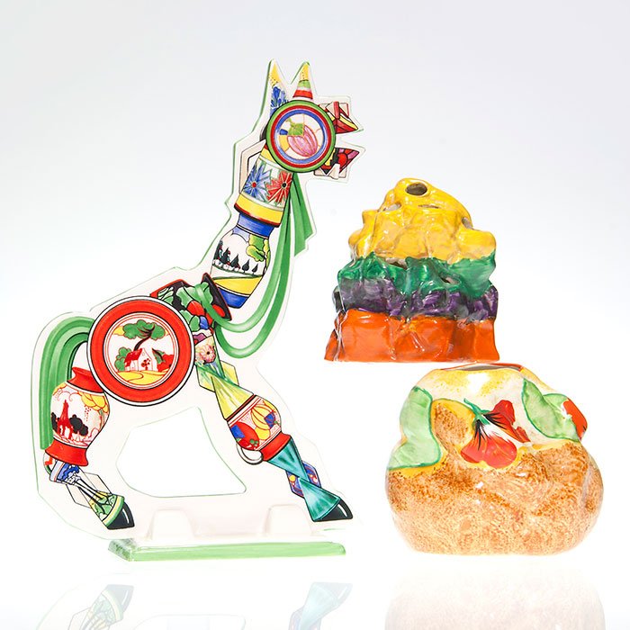 3 Clarice Cliff items, Wedgwood horse, vase, frog: Three Clarice Cliff items consisting a 9 3/4 inch Wedgwood cut-out horse brightly decorated, a four color 4 inch Bizarre flower frog and a 3 1/2 inch Bizarre vase with nasturtiums decor. All have the