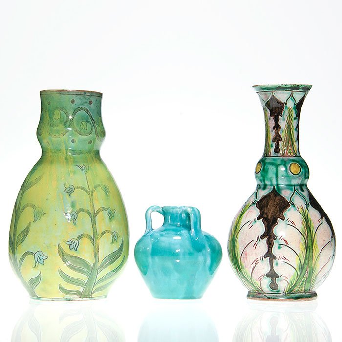 3 Della Robbia (English) vases, 2 decorated, 8”: Three Della Robbia (English) vases consisting of two 8 inch vases with high glaze incised and painted floral or leaf decoration and a 3 1/2 inch tri-handle turquoise vase. All are incised with a saili