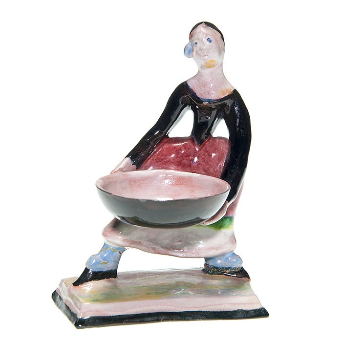 Wiener Werkstatte ring holder, figural,: Wiener Werkstatte ring holder in the form of a young woman holding a large, round basket. Impressed “WW Made in Austria” logo along with the number 468. Height 4 3/8 inches. Both legs broken at th