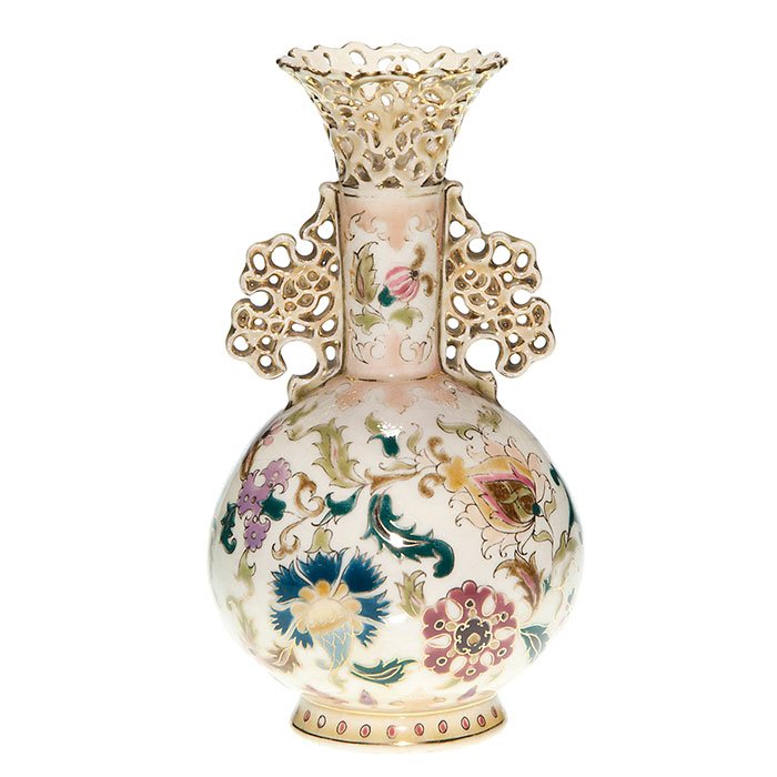 Early Zsolnay vase, reticulated rim & handles, 7 3/4”: Early Zsolnay Pécs vase with reticulated rim and side ornaments. Height 7 3/4 inches. Stylized flowers in complimentary colors with gold accenting. Marked in blue with the Zsolnay Pécs and 5 churche