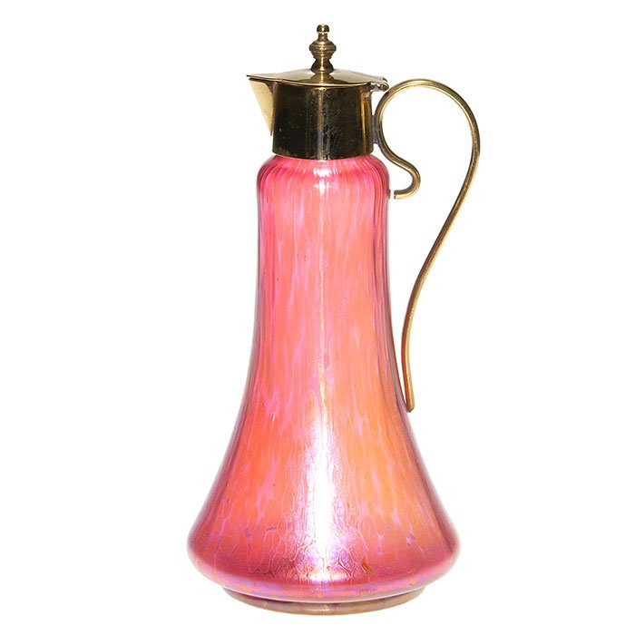 Loetz red Papillon spirit decanter, brass top, 8 1/2”: Attractive red Loetz “Papillon” spirit decanter with a brass collar and hinged cover and curled handle. Height 8 1/2 inches. Beautiful sheen to the glass surface. Excellent condition.