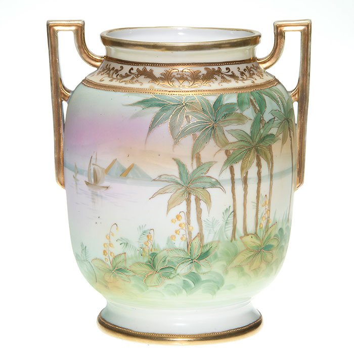 Nippon Egyptian scenic vase, handles, 8 5/8”, marks: Nippon vase with an Egyptian theme showing palm trees and pyramids and a lake in between with sailing vessels afloat. Ornamental raised gold accents the shoulder, the scene and handles are enhanced wi