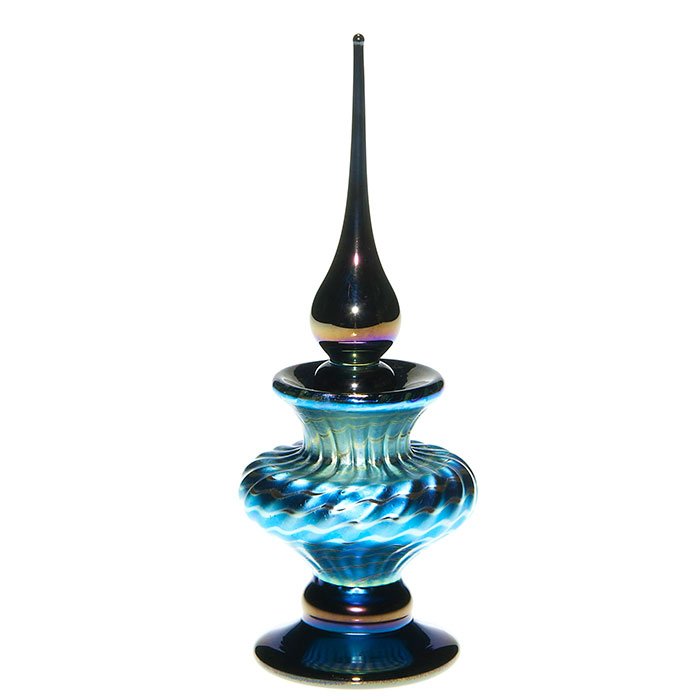 Stuart Abelman perfume, aurene blue, stopper, 6”: Stylish Stuart Abelman perfume in aurene blue with a silvery spiral design over a ribbed body. Golden black are the base and teardrop stopper. Height 6 inches. Engraved “Abelman, 2002” with regist