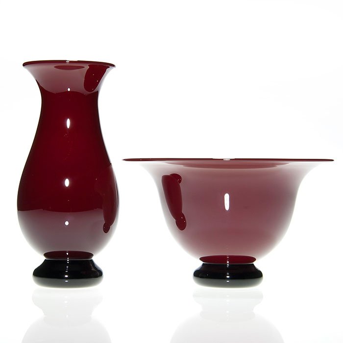 2 Donald Carlson ruby vase & bowl,: Two Donald Carlson items, a 6 1/2 inch pedestal vase and a 3 5/8 by 6 3/8 inch pedestal bowl in ruby and ebony. Both artist signed and dated either 2001 or 2002 respectively. Excellent condition.