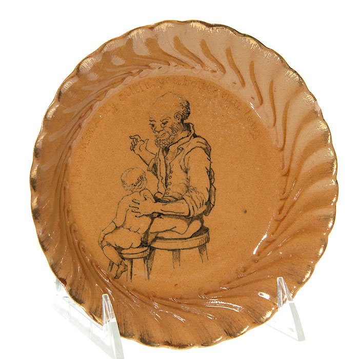 Rookwood dish, Uncle Remus, Cranch, 1886, 6 3/8”: Rookwood dish from 1886 with another E.P. Cranch rendering of a Joel Chandler Harris tale including Uncle Remus himself. Pictured is the old gentleman telling one of his famous stories to a young man 