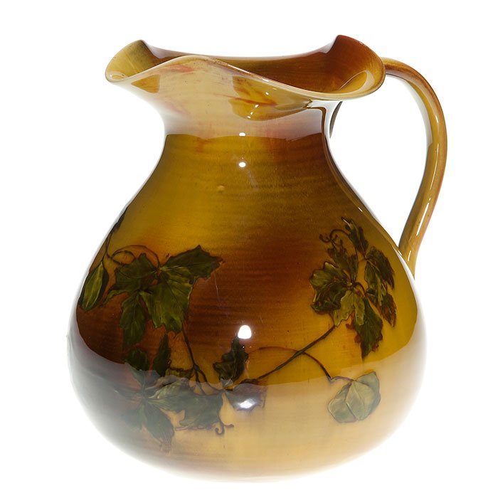 Early Rookwood pitcher, Chinese lantern, 7 1/2”: Early Rookwood Standard Glaze pitcher nicely decorated by Anna Marie Valentien with Chinese lanterns. The ruffled spout pours easily from any side. Measures 7 1/2 inches tall and wide. The company log