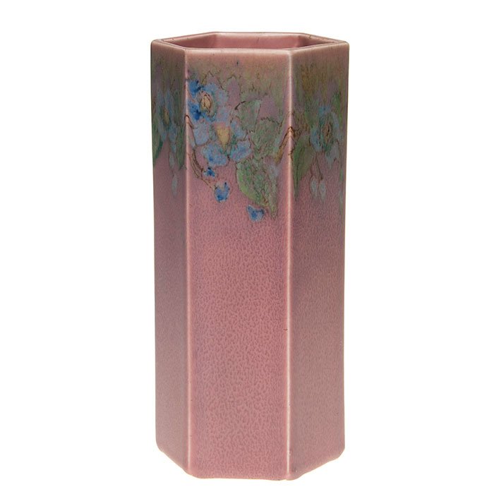 Rookwood Decorated Mat vase, 9 3/4”, Barrett, 2794: Decorated Mat six sided vase, painted by Elizabeth Barrett placing a wreath of blue impressionistic flowers at the rim. Height 9 3/4 inches. Impressed with the Rookwood symbol, shape 2794, the date 19