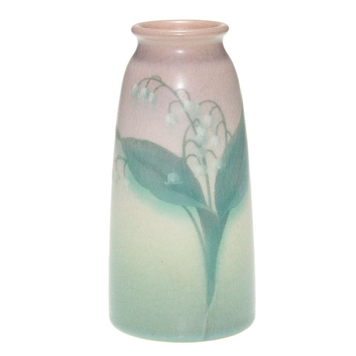 Rookwood Vellum, lilies, Schmidt, 1911, 6 1/2”: Vellum glaze 6 1/2 inch vase decorated with lilies, the work of Carl Schmidt in 1911. Marks include the Rookwood logo, date, shape 1658 F, an incised V and an impressed V for Vellum and the artist’s