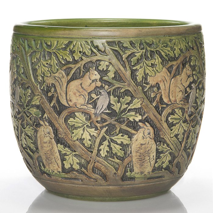 Weller Knifewood jardiniere,owls and squirrels,7 7/8”: Weller Knifewood jardiniere featuring owls, squirrels and birds. Unmarked. There is a bruise at the rim and there appears to have been a professional repair also to the rim. Height is 7 7/8 inches and
