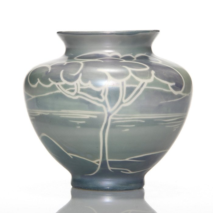 Fraunfelter vase, John Lessell, 4 3/8”: Fraunfelter vase decorated with a stylized landscape in blue and gray with the white body showing through and providing definition. Marked on the base “Fraunfelter U.S.A. 80” and signed by Lessell