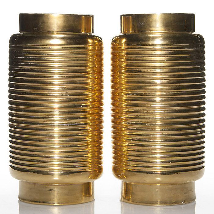 2 Waylande Gregory gold lamp bases, 12”, signed: Two Waylande Gregory Art Deco “lantern” lamp bases in bright shiny gold luster. Heights 12 inches. Both signed in gold by the artist. There are areas where the under surface is visible, otherwise