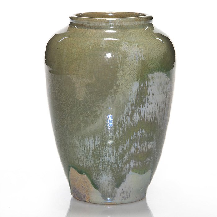 Pewabic light green luster over gray, 6”: Pewabic vase covered with a light green luster glaze over gray. Marked on the bottom with the Pewabic Detroit circular stamp. There is faint crazing and a tiny nick at the base. Height is 6 inches. At