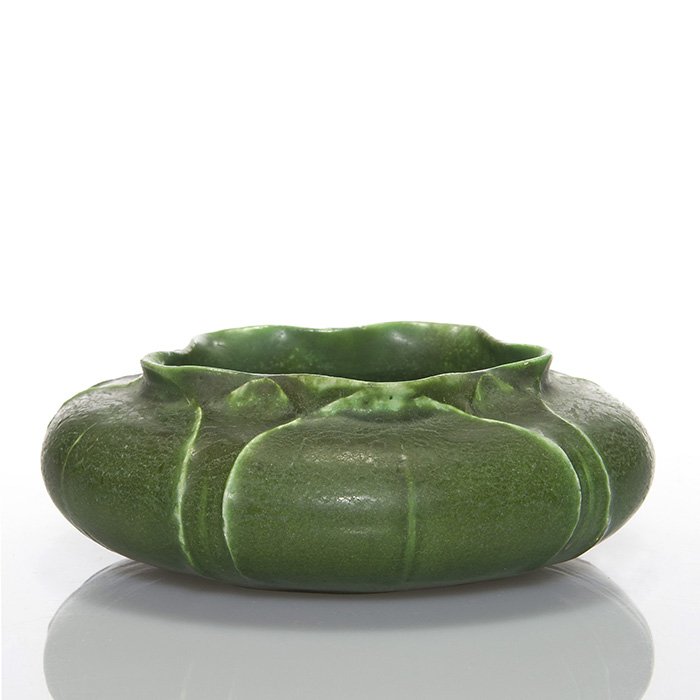 Grueby bowl, tooled flowers, Erickson, 2” x 6”: Grueby flower form bowl covered in a nice mat green glaze. Size is 2 inches high by 6 inches wide. Marked on the bottom with the circular Grueby Pottery Boston USA mark and incised with the initials o