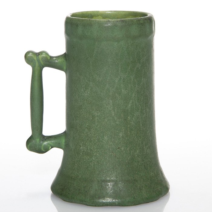Hampshire mug, green, shape 37, 5 1/2”: Hampshire Pottery mug, shape 37, covered in a green mat glaze. Impressed on the bottom HAMPSHIRE, 37, JST&CO KEENE, NH and the Emoretta mark. Excellent original condition. Height is 5 1/2 inches.