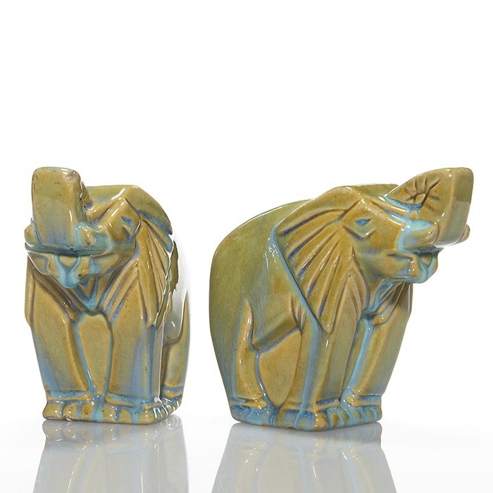 Pair of Fulper(attrib) elephant bookends, 5 1/4”: Pair of Fulper Pottery (attributed) elephant bookends covered with a bright green flambe’ glaze over a mustard colored base. Unmarked. Both pieces have fine overall crazing. One has a chip to his tr