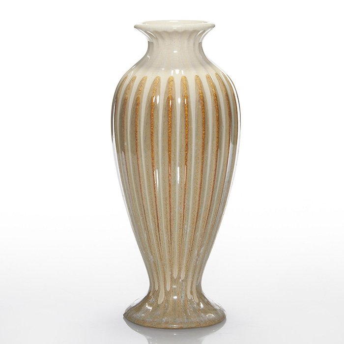 Fulper ribbed vase, 10 3/8”, tan-cream: Fulper Pottery ribbed vase covered in a tan flambe’ glaze over which a cream colored glaze has been dripped from the rim. Impressed “FULPER” in block letters. There is fine overall crazing. Heig