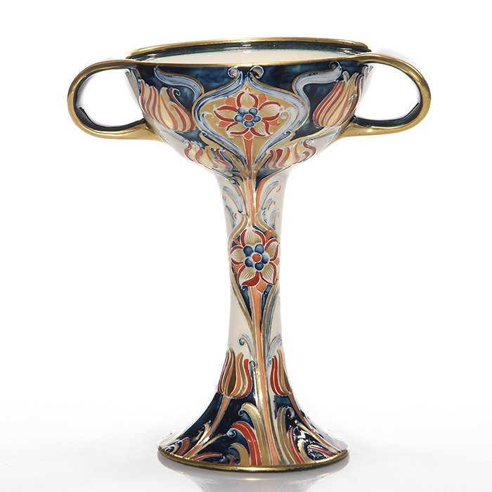 Moorcroft MacIntyre chalice, no lid: Moorcroft MacIntyre handled chalice minus the cover. Height 7 inches. Back stamped “MacIntyre Moorcroft England” logo with registered number. Highly decorative. Fancy jelly compote for Sunday toas