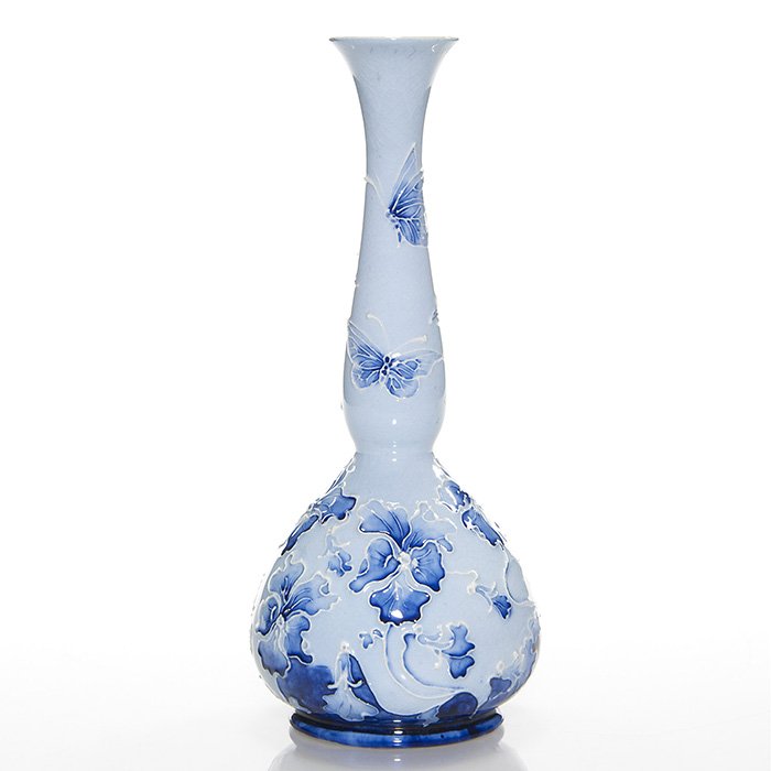 Moorcroft MacIntyre Florian vase, butterflies, 8 3/4”: Moorcroft MacIntyre blue Florian vase with flowers and butterflies. Has the Florian Ware inkstamp, “W.M. Des” incised and M.759 in blue slip on the base. Height is 8 3/4 inches. There is fine over