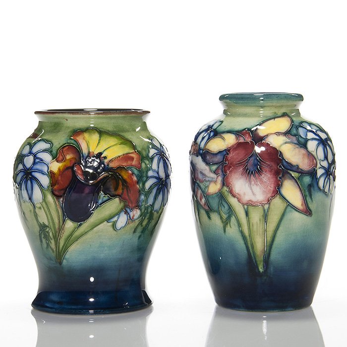2 Moorcroft Orchid vases, 6 1/8” & 5 5/8”: Two Moorcroft “Orchid” vases measuring 6 1/8 inches and 5 5/8 inches. Both impressed “Made in England, W. Moorcroft, HM The Queen” with the slip signature of William Moorcroft. Restoration to 