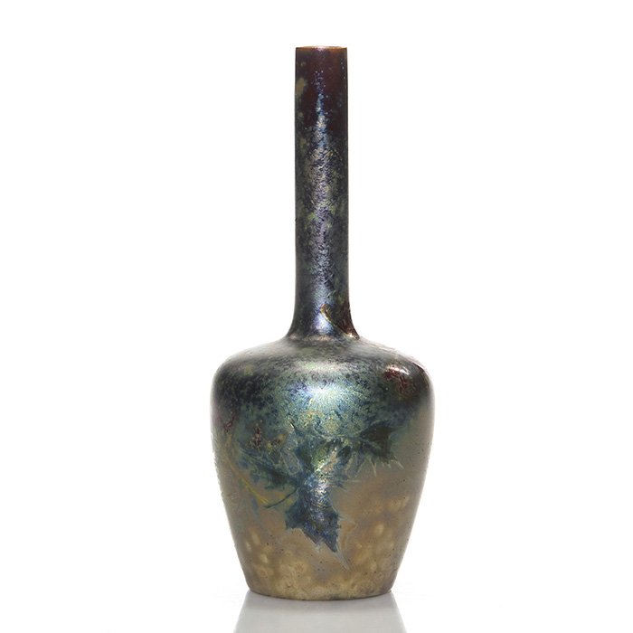 Clement Massier iridescent vase, leaves, 7 1/8”: Clement Massier iridescent vase with leaf decoration. Signed CM on the bottom with other marks difficult to read. Height 7 1/8 inches. Tiny, tiny glaze nicks at the rim.