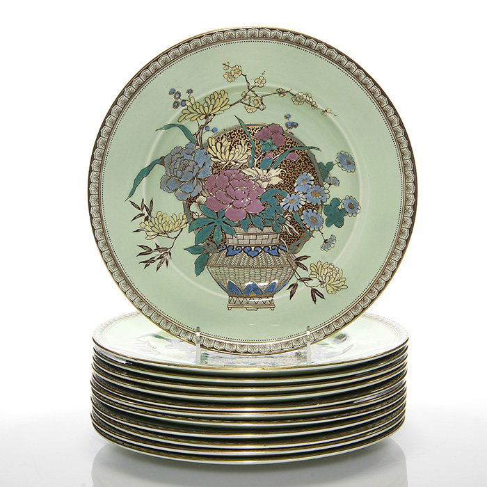 Set of 12 Clarice Cliff “Ophelia” plates, 10 3/4”: Set of 12 Clarice Cliff “Ophelia” Royal Staffordshire plates in celadon green with garden flowers arranged in a woven vase, 10 3/4 inches diameter. Back stamped “Clarice Cliff, Wilkinson, Englan