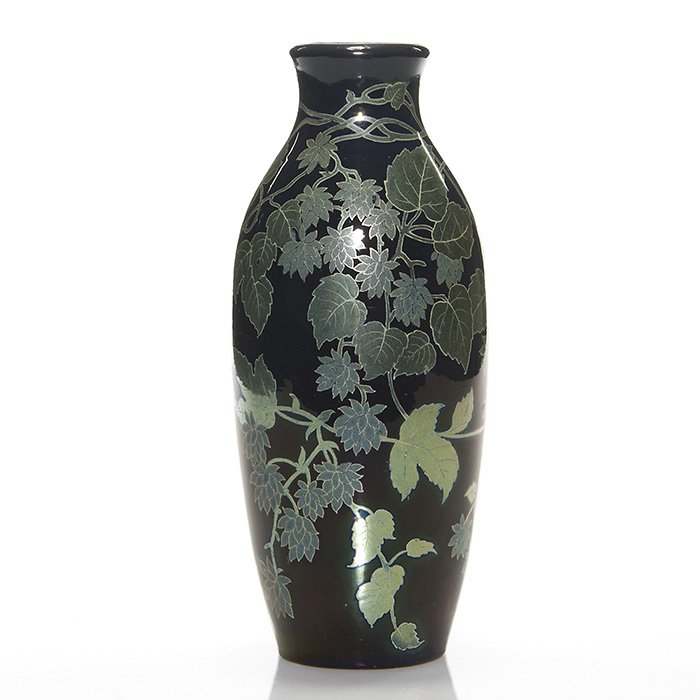 Zsolnay blue vase with leaves and vines, 8 1/4”: Zsolnay blue vase decorated with leaves and vines in the Eosin glaze. Impressed on the base 7661 and having the 5 churches logo with “Made in Hungary”. There are a few small rubs to the glaze and 