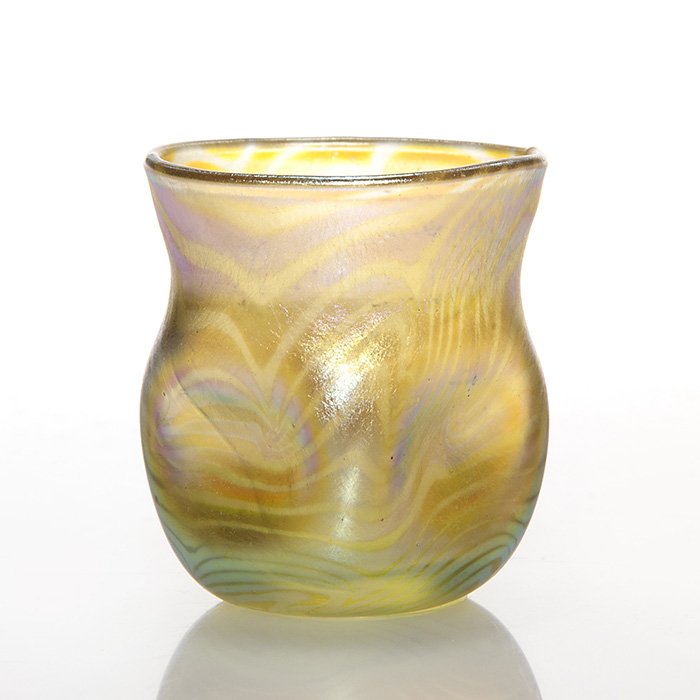 Unusual Tiffany cordial, pulled feather, 1 1/2”: Choice Tifffany cordial unusually decorated with the King Tut design over a dimpled body. Height 1 1/2 inches. Engraved “L.C.T. D1271” about the polished pontil. A glorious halo of color radiates