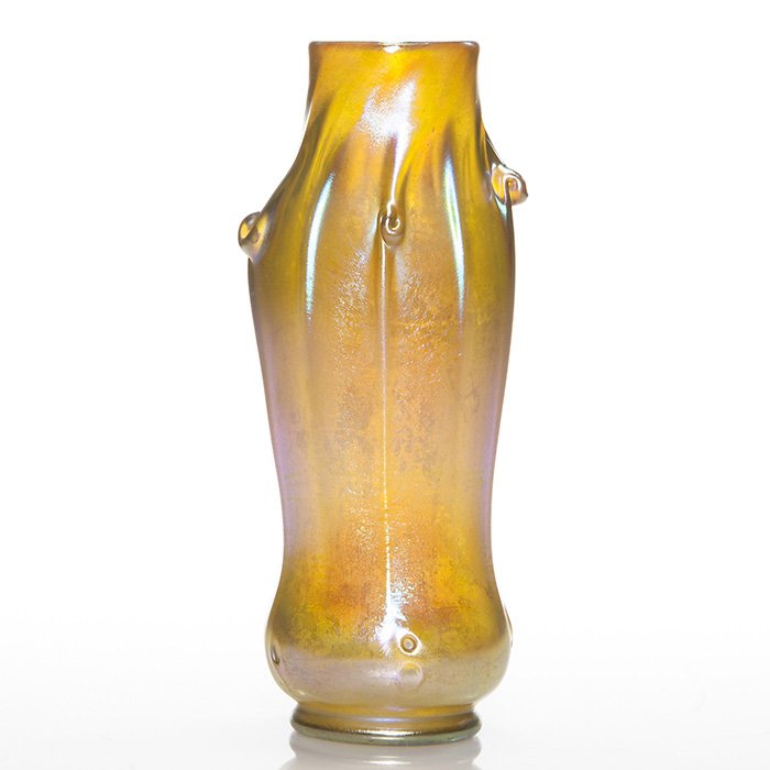 Tiffany “pig tail” vase, 10”, gold, signed: Shapely Tiffany iridescent gold vase with “pig tails” tooled on the shoulder separated by defined ribbing and showing traces of additional tooling near the base. Height 10 inches. Engraved “L.C.