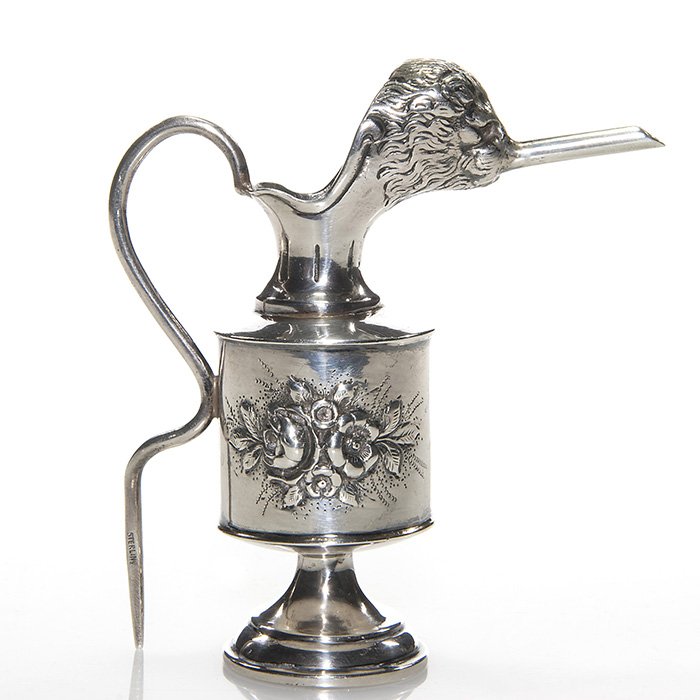 Sterling “hedgehog” mini oil canister, 4”, marked: Unusual sterling repoussé small container possibly English. The spout formed as the head of a shrew having a very long snout from which to funnel fluid. The serpentine handle, impressed “Sterling��