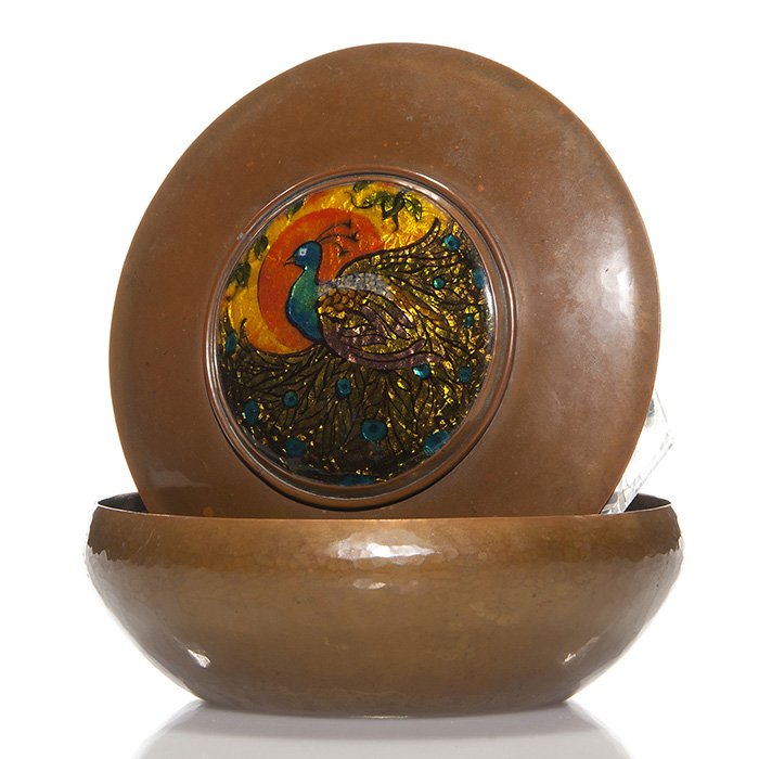 Copper covered box, foil enamel peacock, 3X7”: Good Arts & Crafts copper covered box, the lid having foil and enamel inset displaying a majestic male peacock before an orange sun and yellow sky. The copper surfaces are lightly hammered and heather