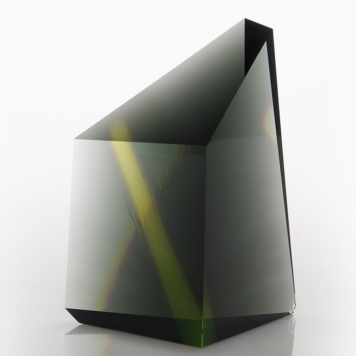 Mark Peiser geometric pyramid sculpture, 7”, 1982: Early Mark Peiser geometric pyramid, “Innerspace” series produced in 1982. The solid smoke gray form displays a solitary green beacon within. Five sides are angle cut then hand polished to perfect