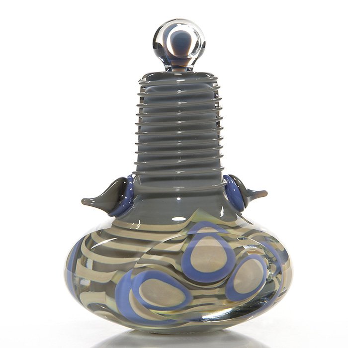 Robert Levin perfume, faceted, prunts, 6”, sign, ‘81: Early Robert Levin paperweight perfume with stopper. The clear faceted bottle reveals a gray core, toffee ribbons and lavender & tan forms, the neck wrapped in gray threads and adorned with twin Hersh