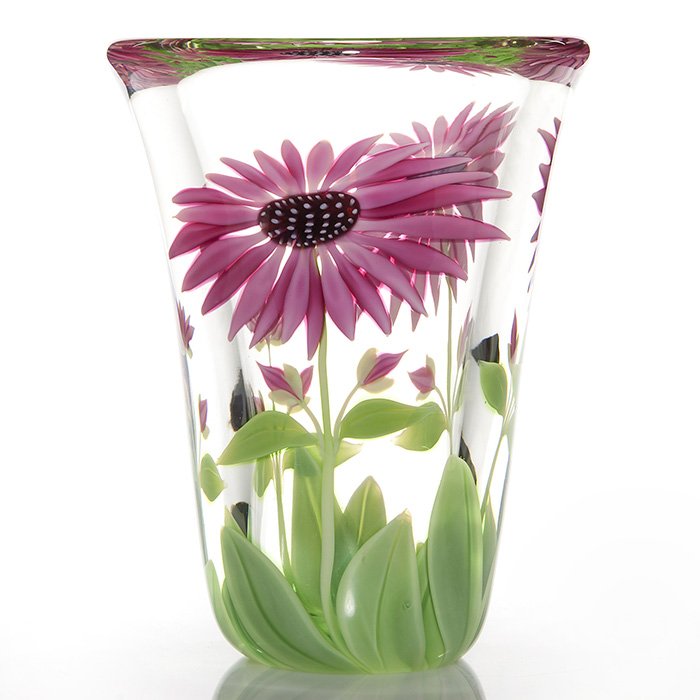 Orient & Flume paperweight vase, pink daisies, 9 3/4: Orient & Flume paperweight vase with two large sunflowers spread with hot pink petals accompanied by smaller buds and several broad green leaves, an artistic design by Scott Bayless. Height 9 3/4 inch
