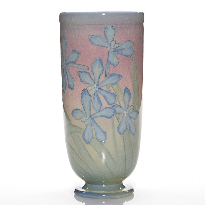 Rookwood Design Crystal, orchids, KS, 1946, 9 3/8”: Rookwood Design Crystal footed vase with blue orchids and green leaves against a rose ground, the work of Kataro Shirayamadani in 1946. Eight fully open flowers grace most of the surface of the vase. 