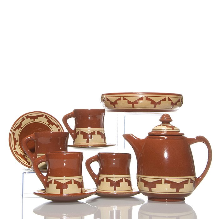 11 piece Pine Ridge coffee set, carved design, 7 3/8”: Pine Ridge Pottery 11 piece coffee set with carved geometric Native American designs, consisting of coffee pot with lid, 4 cups and 4 saucers and a low bowl. All have an incised pine tree and ridge al