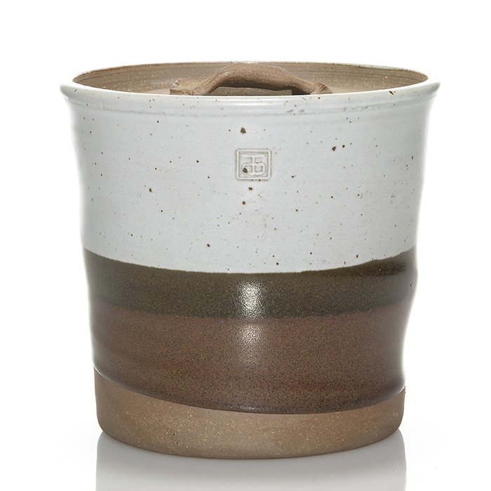 Byron Temple covered jar, 5 7/8”: Byron Temple lidded stoneware jar with bands of white, dark and light brown glazes. The lid and lower portion of the jar are unglazed. Impressed artist’s mark on the side of the piece. Height is 5 7