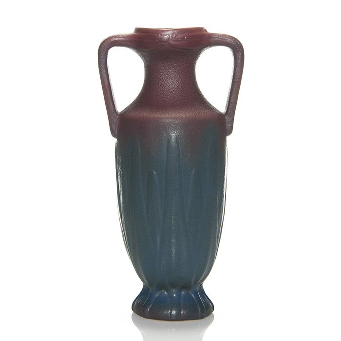 Tall Van Briggle yucca vase, Mulberry glaze, 13”: Van Briggle twin handled vase with a yucca leaf design and covered with the Mulberry glaze. Crisp mold. Marked on the bottom with the company logo, Van Briggle and Colo.Sprgs. Height is 13 inches. In