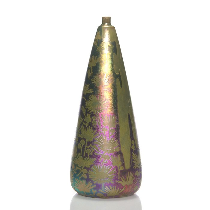 Massier iridescent vase, floral designs: Massier tapered iridescent vase, all over decorated with daisy sprigs and an area that has what resembles the shadow of a human figure walking through the flowers. Height 9 1/4 inches. Impressed “Cl