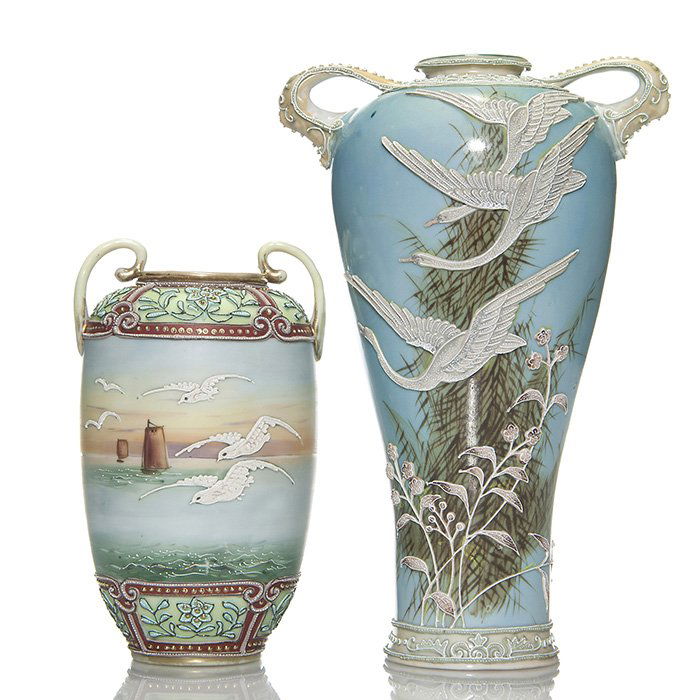 2 Nippon Moriage vases:10” w/geese, 7” w/ seagulls: Two Nippon Moriage handled vases. 1) Turquoise 10 inch with geese in flight & painted grasses, a flock of birds on obverse. Unmarked. Few raised pattern chips. 2) A 7 inch Harbor scene with relief des