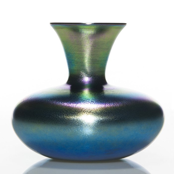 Victor Durand iridescent vase,blue,5 5/8”,shape 1986: Victor Durand blue squat bodied vase dazzling with aurora rings about the shoulder. Measures 5 5/8 inches by 7 inches across. Marked in silver “V. Durand” with the shape and size, 1986-6-D. Flashy