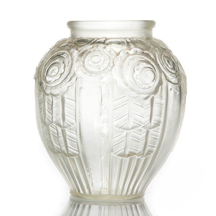 Andre Hunebelle Art Deco vase, floral, 6”, marked: Andre Hunebelle frost & clear Art Deco vase with stylized floral about the shoulder and overlapping of leaves on the side. Height 6 inches. Traces of tan patina in the recesses. Mold marked “A. Hune