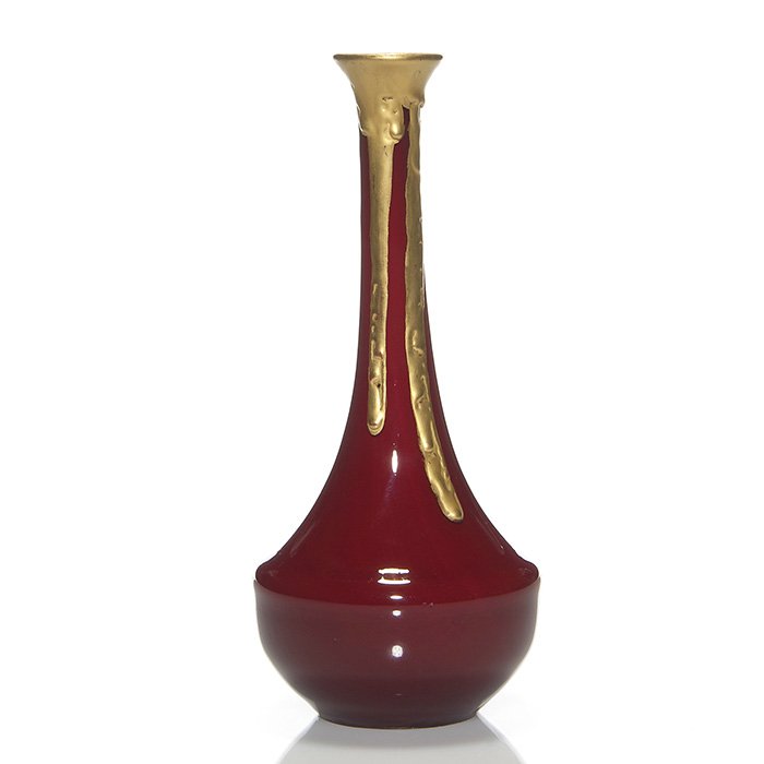 Daum vase, gold drip over oxblood red, 9”: Slender Daum Fréres & Cie vase in oxblood red, drizzled with a thick application of gold gliding down the neck and drifting down the white coated interior. Height 9 inches. Merely marked “D 1908”
