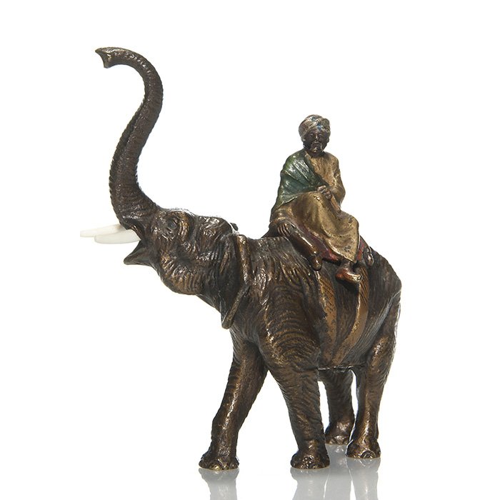 Austrian bronze man on elephant, 4 1/2”: Austrian figural cold painted bronze of an elephant with trunk up transporting a Middle Eastern man. Measures 4 1/2 inches by 5 1/2 inches. Unmarked. Good color and well detailed.