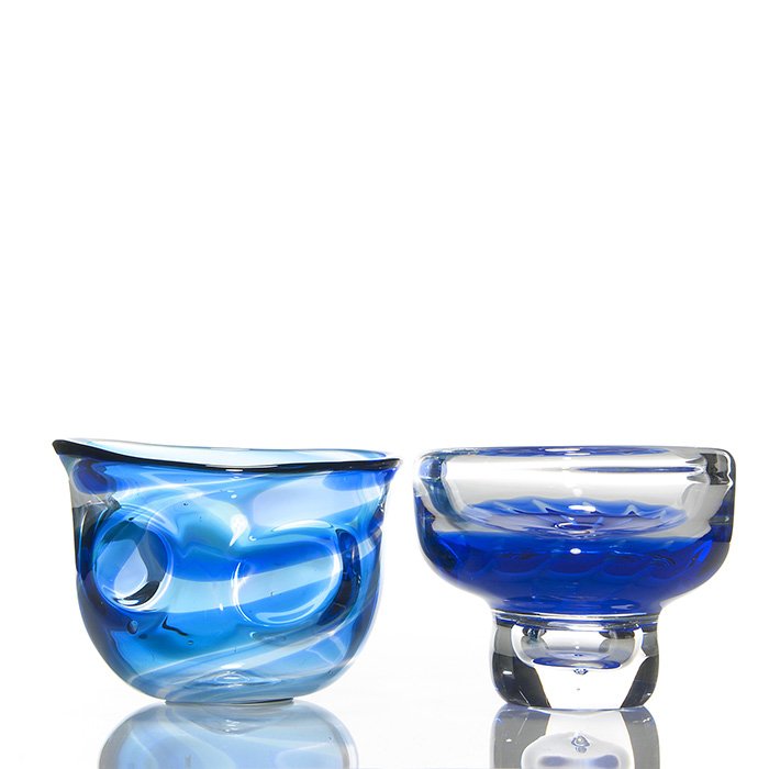 2 Goran Warff vases, 5 1/4”, blue, signed: Two Goran Warff vases. First a free form vase with green and blue swirl pattern within and a melt of prunts applied to the exterior. Measures 5 1/4 inches by 7 3/8 inches. Engraved “Kosta, Warff, Un