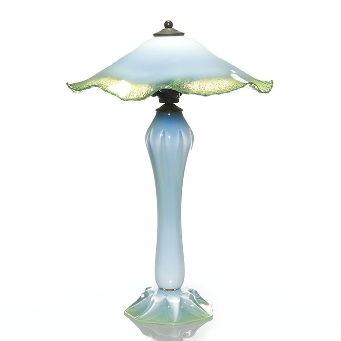 Jeremiah Lotton lamp, green opalescent, 22”, 2006: Sleek Jeremiah Lotton lamp in a pleasing opal blue green. The ruffled shade measuring 14 inches across and having a bright rainbow interior consisting of magenta, purple blue, orange, yellow and of co
