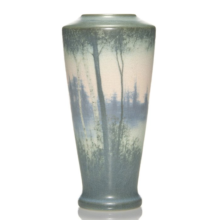 Rookwood Vellum vase, scenic, Hurley, 1914, 9 1/8”: Vellum glaze scenic vase with birch trees along the edge of a lake with soft pink skies, the work of E.T. Hurley in 1914. Marks include the Rookwood logo, date, shape 1663 D, impressed with a V for Ve