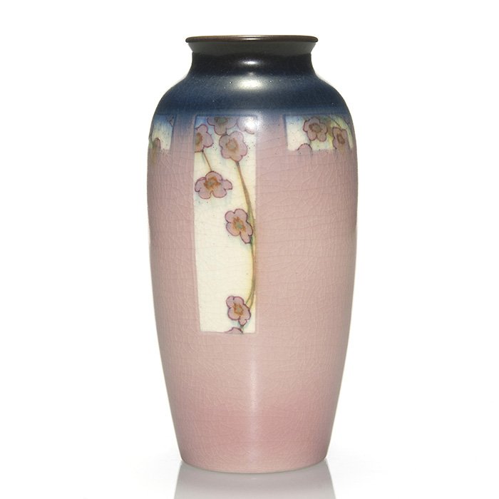Rookwood vellum,floral McLaughlin, 1916, 7 3/4”: Vellum Glaze vase encircled with white panels against a blue and pink ground, each panel being decorated with pink cherry blossoms by Charles McLaughlin in 1916. Marks include the Rookwood logo, date,