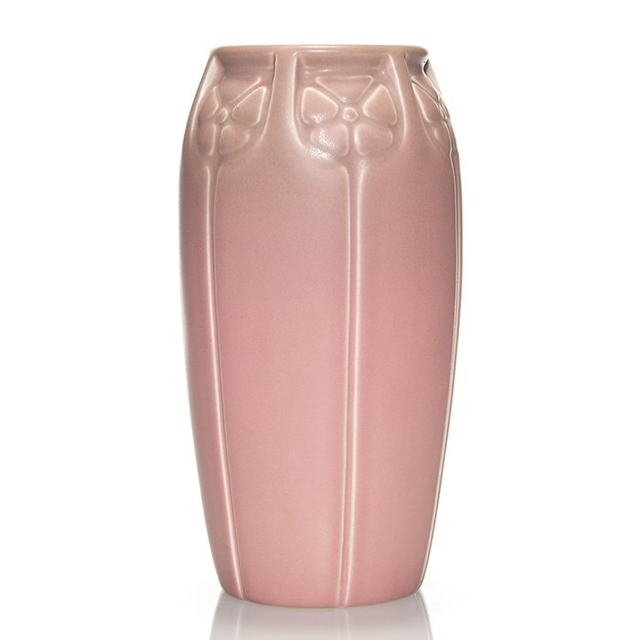 Rookwood production vase, pink, 1928, 2431, 9 1/4”: Production vase with molded floral design cast in 1928, completely covered in a pink mat glaze with just a bit of green mat added at the rim. Marks include the Rookwood logo, date and shape 2431. In e