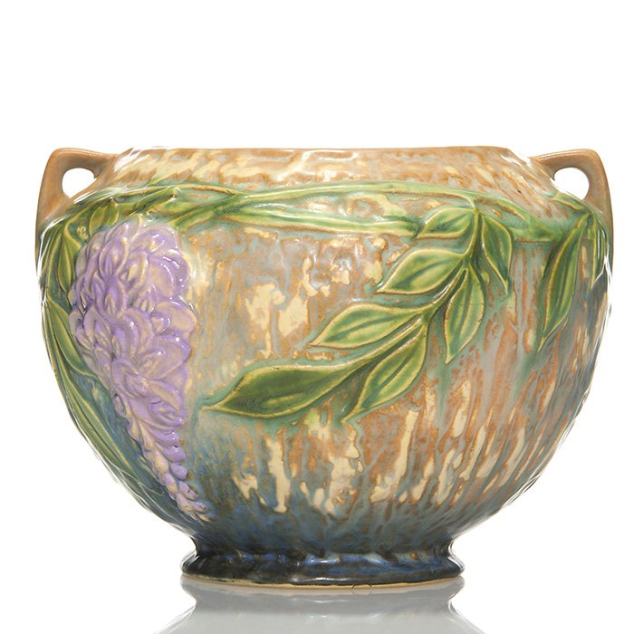 Roseville Wisteria footed vase, 5”, blue, shape 254: Wisteria footed round vase in blue in shape 254. Measures 5 inches by 7 inches across. Teensy open bubble on foot, otherwise excellent condition with a crisp mold and good color.
