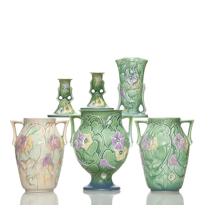 5 Morning Glory items, with minor issues, 9 1/8”: Five Roseville Morning Glory items, each with a minor issue. 1. Green candlesticks, shape 1102-4 1/2 with repair to one handle. 2. Shape 727-8 in white with peppering around the top of the rim and han